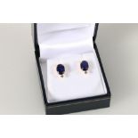 Pair of 18ct yellow studs set with treated sapphires and diamonds, sapphire weight approximately