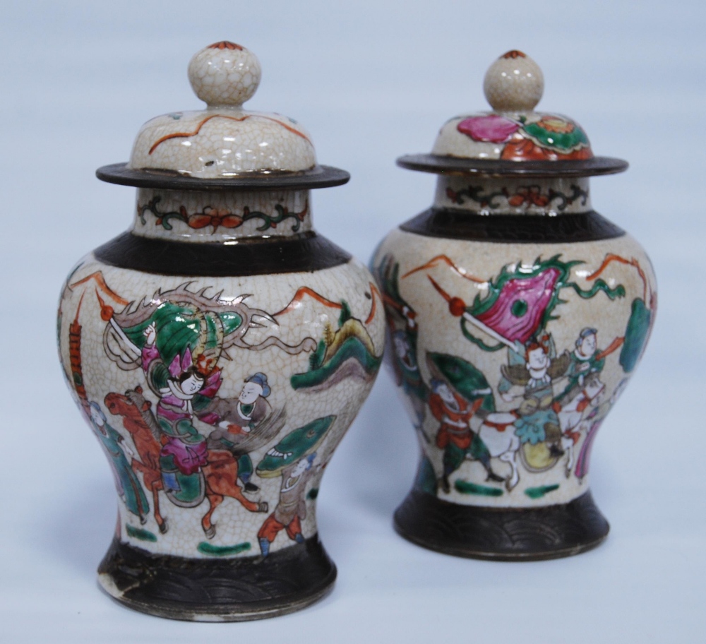 Pair of Chinese crackle glazed baluster vases and covers (20th century) decorated with battle scenes