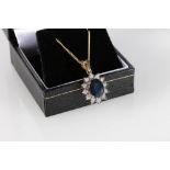 9ct yellow gold oval sapphire and diamond cluster pendant on a gold-coated silver chain, sapphire