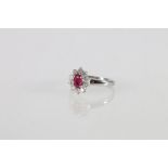 18ct white gold oval ruby and round brilliant-cut diamond cluster ring, ruby approximately .5ct,