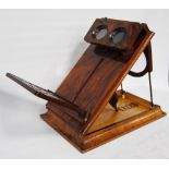 Victorian burr walnut stereoscopic table viewer, the table tilting on a ratcheted bracket with