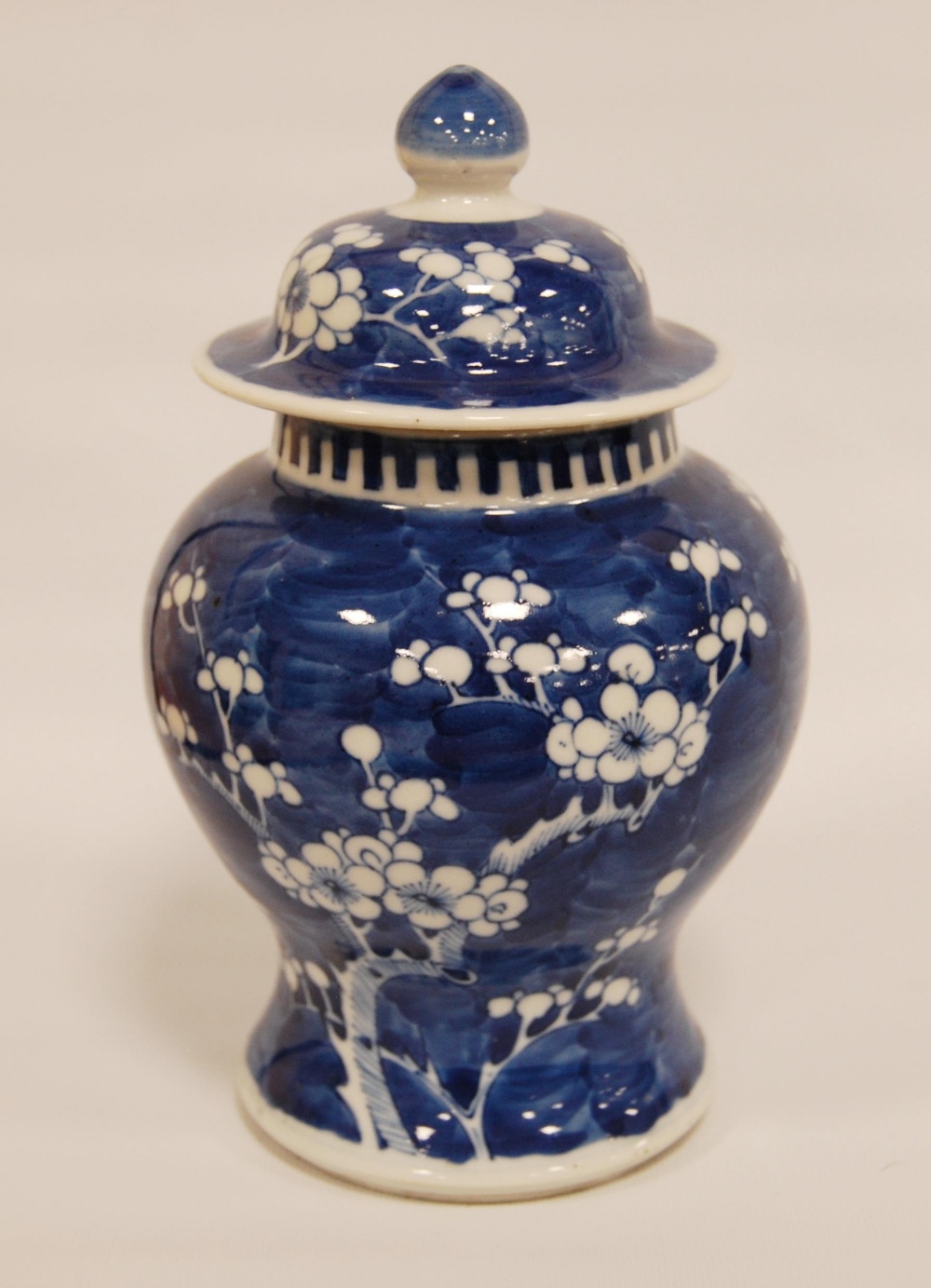 Chinese blue and white vase and cover of baluster form with flowering prunus trees, bearing four