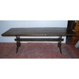 Arts & Crafts-style oak refectory table with long plank top, on trestle ends united by a peg-jointed