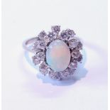 Opal and diamond oval cluster ring with two tiers of brilliants, in white gold, '18ct', size Q.