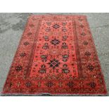 Afghan Khal Mohammadi rug with all over floral and geometric lozenges on blue, cream and red ground,