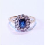 Diamond and sapphire oval cluster ring with twelve old-cut brilliants, all millegrain, in '18ct' and