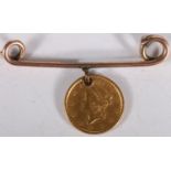UNITED STATES OF AMERICA gold dollar 1853 holed and mounted on a bar brooch, 2.7g gross.