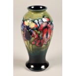 Moorcroft pottery vase, baluster form, decorated with orchid pattern, signed and incised