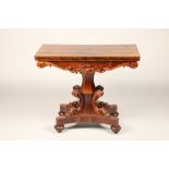 Victorian rosewood fold over games table on central column with four supports on quadraform base