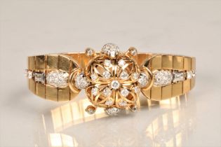 Ladies 18k gold diamond encrusted Longines wrist watch. The diamond encrusted case opens to reveal a