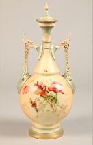 Royal Worcester twin handled vase and cover, baluster form with rectangular handles, decorated