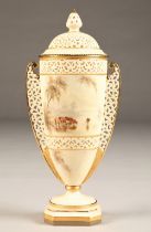 Royal China Works Worcester double handled reticulated vase and cover, raised on a square foot, hand