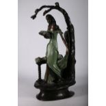 Signed patinated bronze figure modelled as a painted clad female holding a basket of flowers, beside
