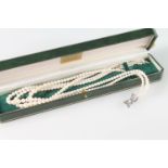 Three strand cultured pearl necklace with 18ct white gold stylized box clasp with chip diamonds,