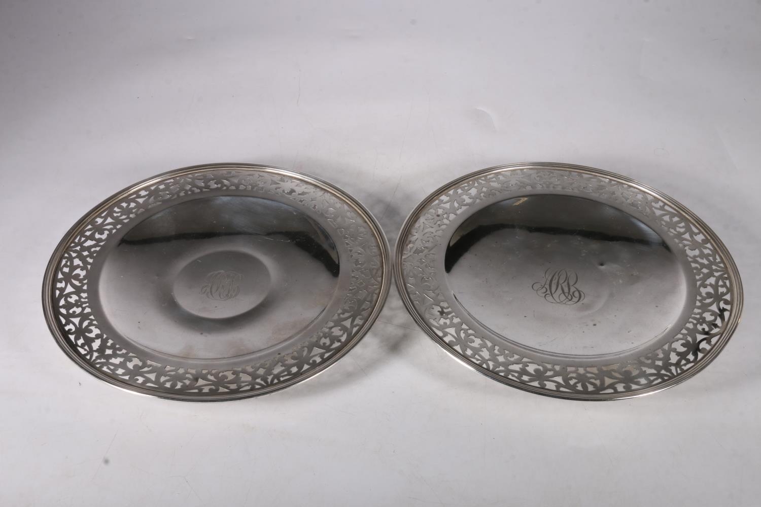 Pair of silver pierced footed dishes with monogram to well and marked sterling to base with other