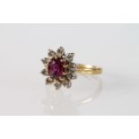 18ct gold cluster ring with 10 diamonds encircling purple/red oval cut stone, size N, 3.8g,