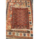Kazak designed rug with three medallions to field within multiple borders, 178 x 133cm, and a