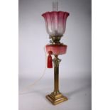 Youngs brass oil lamp circa early 20th century with later tinted glass shade and funnel above opaque