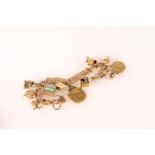 9ct gold charm bracelet with quantity of charms, including a sovereign and half sovereign, 57g