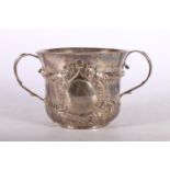 George I silver porringer with scroll handles and repousse decoration, hallmarked London 1720,