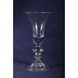 18th Century heavy baluster wine glass, trumpet bowl, double knop and folded foot, 21cm.