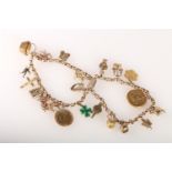 9ct gold charm bracelet with 21 charms, including a full and half sovereign, 49.5g gross.