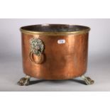 Victorian copper and brass log bin with lion mask carrying handles to either side and raised on