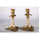 Pair of brass and ceramic flower head candlesticks with Koi fish decorated to the stem, 21cm tall.