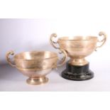 Pair of silver twin double scroll handled hemispherical prize cups with ‘Vincit Qui Patitur’ crest