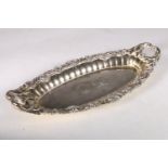 George III gilt silver oval dish with twin handles, chased cast scroll and shell border with two
