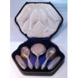 Silver five-piece toilet set with moulded edges, cased.