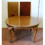 Chippendale Revival mahogany circular dining table with two additional leaves, on moulded cabriole