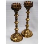 Pair of brass Gothic-style ecclesiastical candlesticks, each with pierced foliate decoration above a