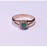 Diamond and emerald cluster ring on bifurcated gold band, size M.