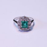 Diamond and emerald oval cluster ring with rectangular emerald, approximately 5.5mm x 6mm, with
