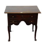 George III oak lowboy with a long drawer above two short drawers and a shaped apron, on cabriole