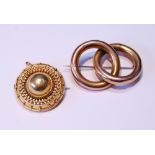 Gold tubular brooch with entwined hoops and a gold boss brooch.