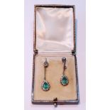 Pair of Edwardian diamond and emerald drop earrings, each with a pear-shaped cluster dependant by