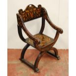 Stained wood penwork Savonarola-type chair, richly decorated with panels of scrolls, urns and
