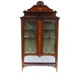 Edwardian inlaid mahogany display cabinet in the manner of Edwards & Roberts, the carved pediment