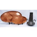 Hugh Wallace (1871-1943) two Arts & Crafts oval copper trays of graduated size, each with