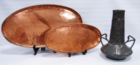 Hugh Wallace (1871-1943) two Arts & Crafts oval copper trays of graduated size, each with