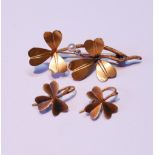 Edwardian gold brooch with two clover leaves, a pearl and tiny diamond, and the matching earrings,