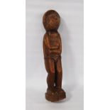 Tribal wooden figure, possibly of Polynesian origin, the arms in folded position, incised painted