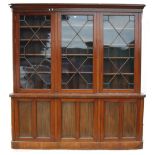 Late Victorian / Edwardian inlaid mahogany library bookcase, the shaped dentil cornice above three