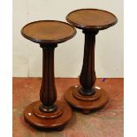 Pair of Victorian mahogany stands, each with a saucer top above a fluted column and circular