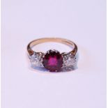 Three-stone ruby and diamond ring, the almost-circular ruby approximately 6mm x 7mm, with two old-