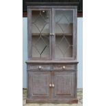 Stained wood bookcase by Maple & Co., with two astragal glazed doors enclosing a shelved interior