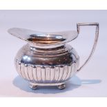 Silver cream jug of gadrooned ovoid shape by Walker & Hall, Sheffield 1897, 152g or 5oz.