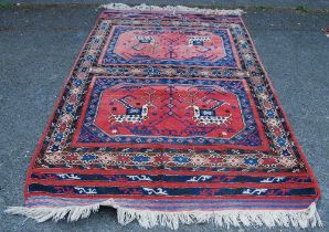 Turkish Milas hand-knotted rug with two panels of nomadic animals within geometric motifs and